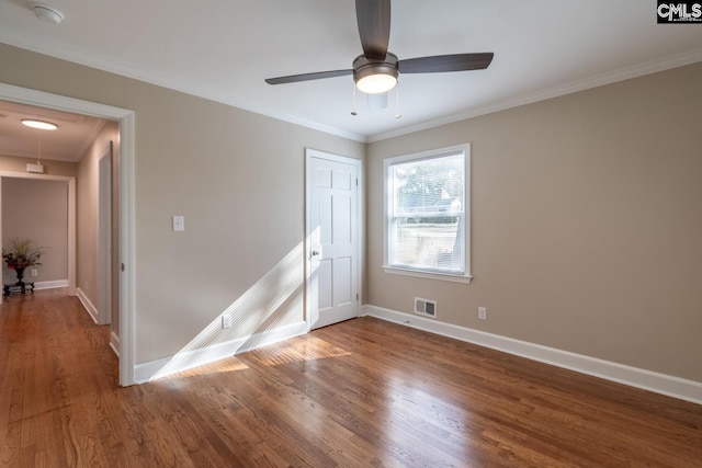 unfurnished room with ceiling fan, crown molding, and hardwood / wood-style flooring