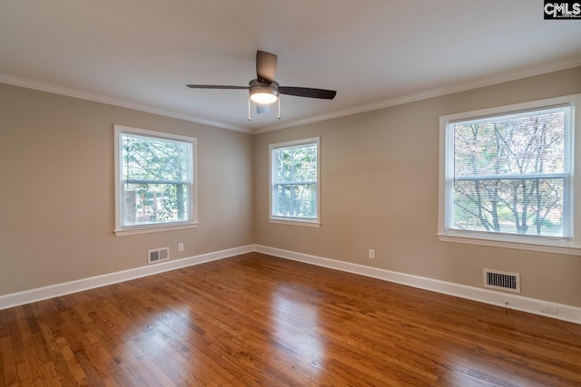 spare room with ceiling fan, hardwood / wood-style flooring, and crown molding