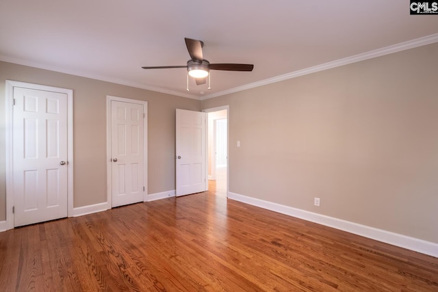 unfurnished bedroom with ceiling fan, ornamental molding, and hardwood / wood-style flooring