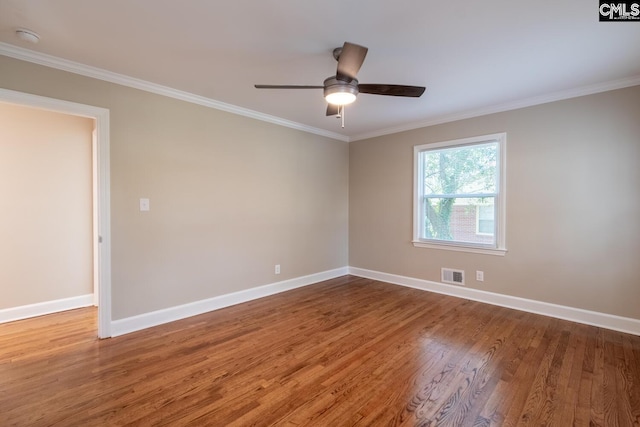 spare room featuring wood-type flooring, ornamental molding, and ceiling fan