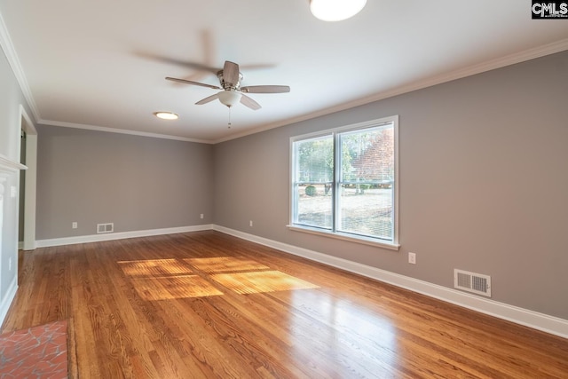 empty room featuring hardwood / wood-style flooring, ceiling fan, and ornamental molding