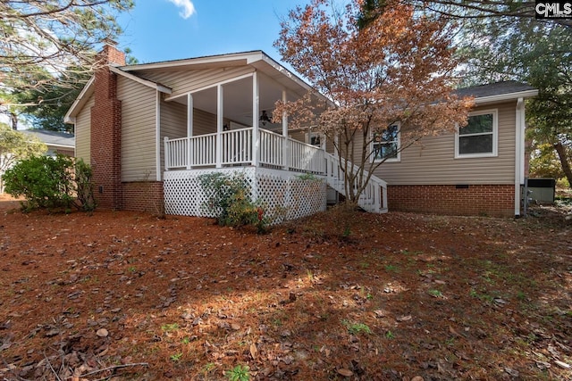 rear view of property with covered porch