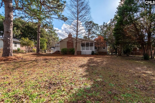 view of yard featuring a sunroom