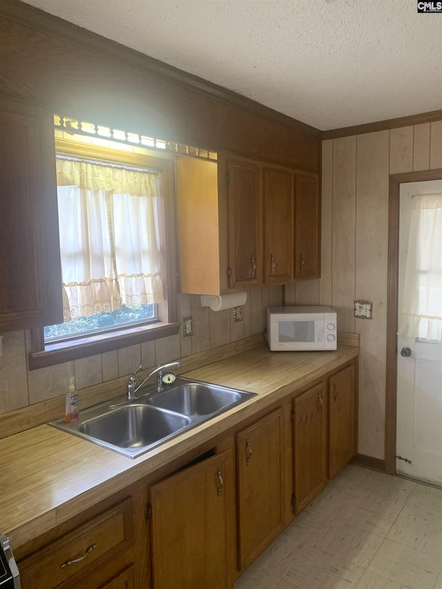 kitchen featuring sink and a textured ceiling