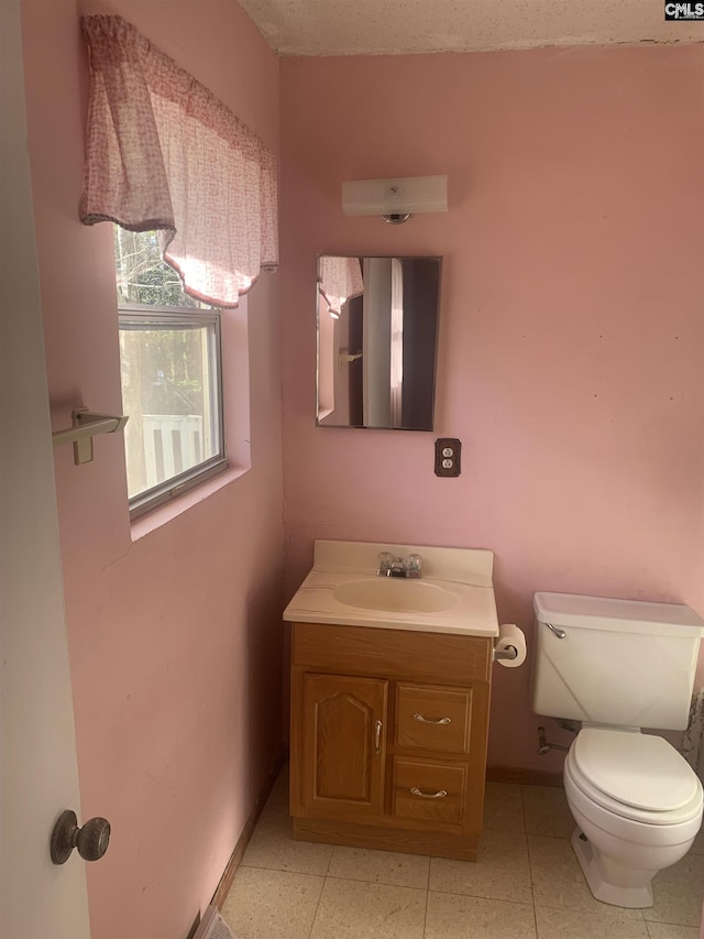 bathroom featuring toilet and vanity