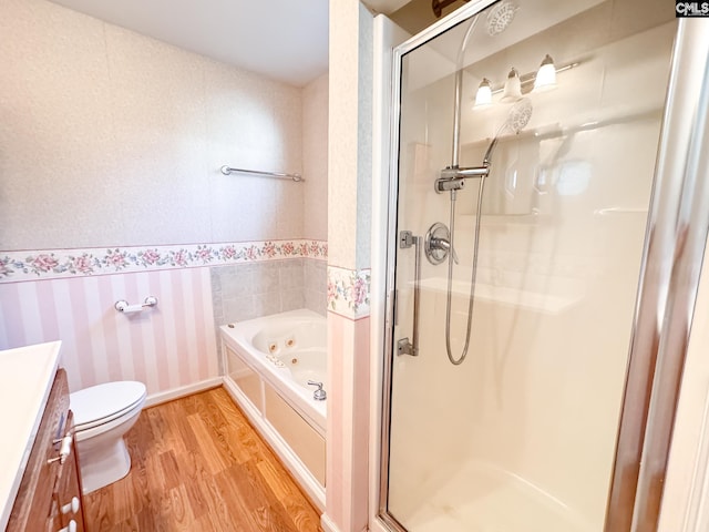 full bathroom with toilet, wood-type flooring, vanity, and independent shower and bath