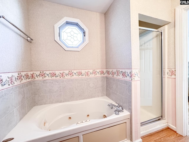 bathroom featuring wood-type flooring and independent shower and bath