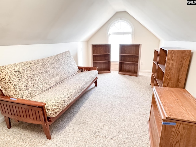 sitting room with light colored carpet and vaulted ceiling