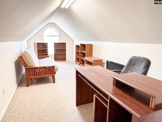 office with vaulted ceiling and light carpet