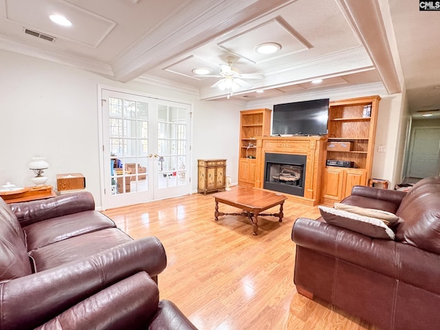 living room featuring french doors, ceiling fan, light hardwood / wood-style floors, crown molding, and beam ceiling