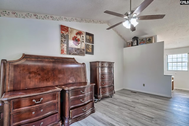 bedroom featuring ceiling fan, light hardwood / wood-style flooring, and vaulted ceiling