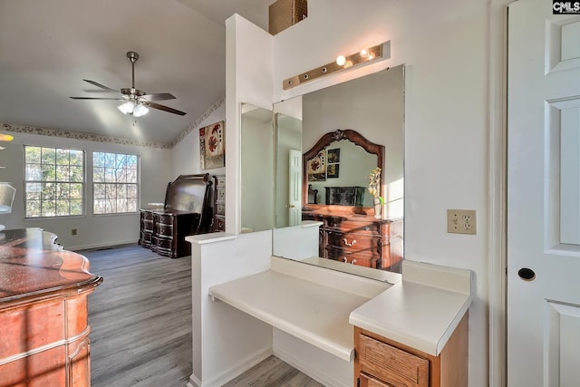 interior space with ceiling fan, vaulted ceiling, and light hardwood / wood-style flooring