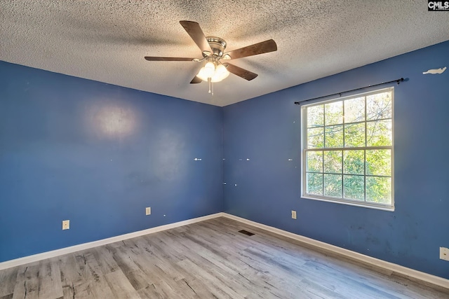 spare room featuring hardwood / wood-style flooring, a textured ceiling, and ceiling fan