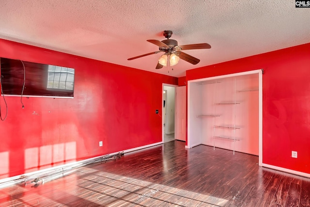 empty room with hardwood / wood-style flooring, a textured ceiling, and ceiling fan