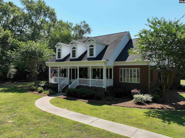 new england style home with covered porch and a front lawn