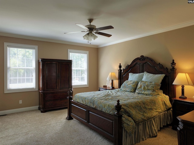 carpeted bedroom with ceiling fan and ornamental molding