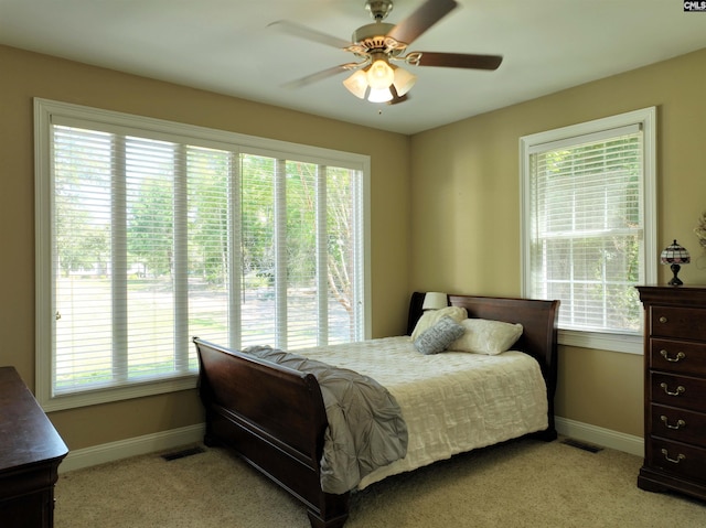 bedroom with ceiling fan and light colored carpet