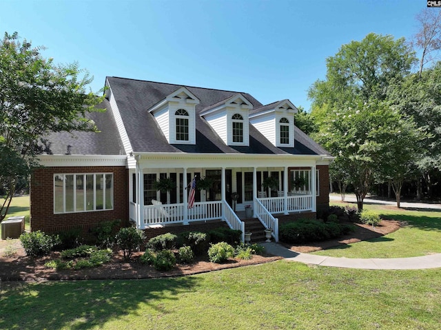 cape cod house featuring a front yard, a porch, and central AC