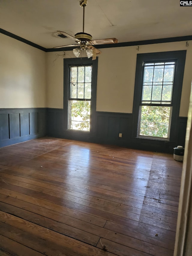 unfurnished room featuring ornamental molding, ceiling fan, and dark hardwood / wood-style floors