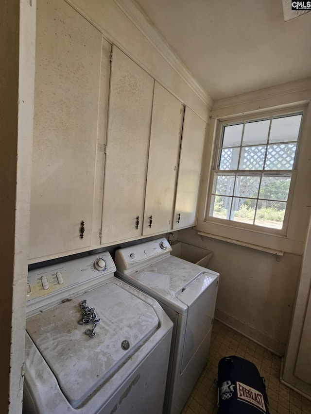 washroom with sink, cabinets, washer and clothes dryer, and ornamental molding