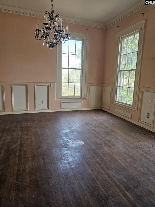 unfurnished dining area featuring hardwood / wood-style floors, an inviting chandelier, and plenty of natural light