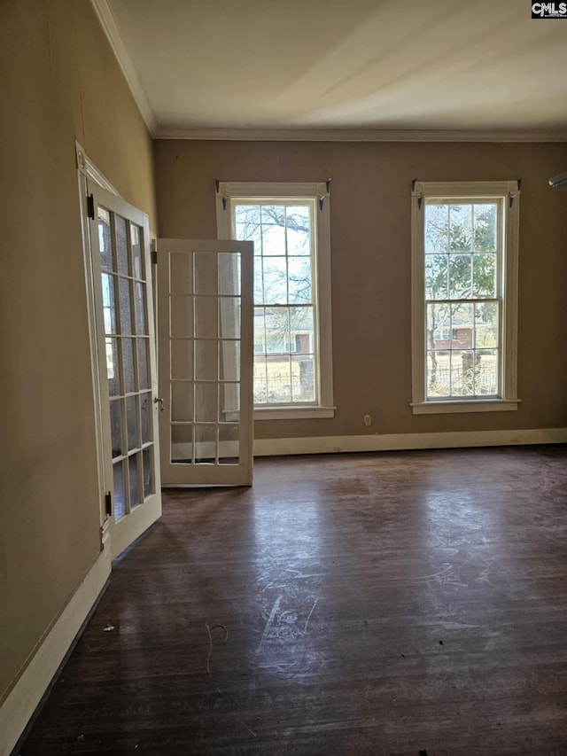 unfurnished room featuring french doors, ornamental molding, and dark hardwood / wood-style flooring