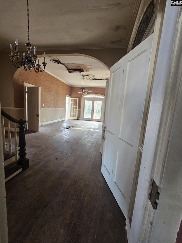 hallway featuring a notable chandelier, dark hardwood / wood-style flooring, and crown molding