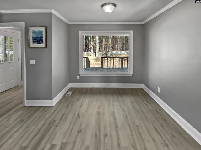 unfurnished dining area with ornamental molding and light hardwood / wood-style flooring