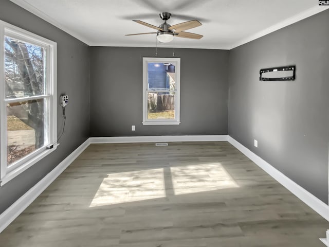 empty room featuring ornamental molding, ceiling fan, and light hardwood / wood-style flooring