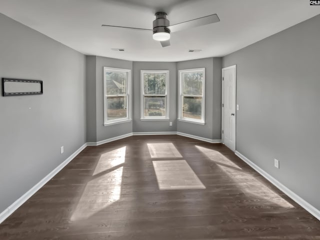 empty room featuring ceiling fan and dark hardwood / wood-style floors