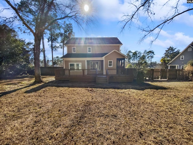 rear view of house featuring a wooden deck