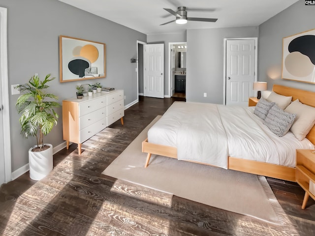 bedroom with ceiling fan, ensuite bath, and dark hardwood / wood-style floors