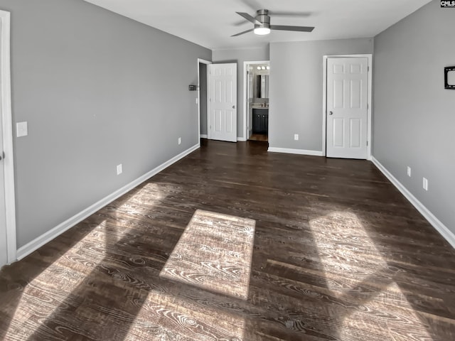 unfurnished bedroom with ensuite bath, ceiling fan, and dark hardwood / wood-style flooring