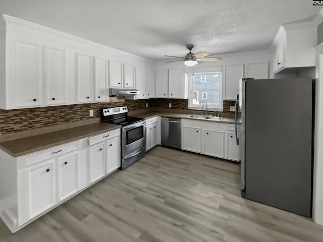 kitchen featuring appliances with stainless steel finishes, white cabinetry, and sink