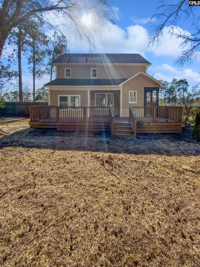 rear view of house featuring a wooden deck