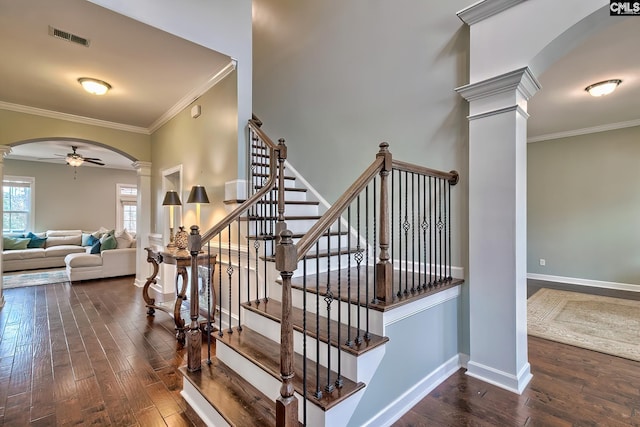 staircase featuring ornate columns, crown molding, hardwood / wood-style flooring, and ceiling fan