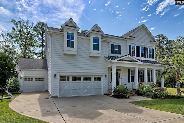 view of front facade with a garage, a front yard, and covered porch