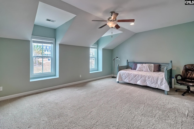 carpeted bedroom featuring multiple windows, vaulted ceiling, and ceiling fan