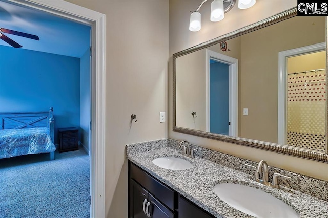 bathroom featuring vanity, curtained shower, and ceiling fan