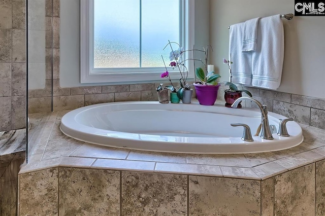 bathroom featuring tiled bath