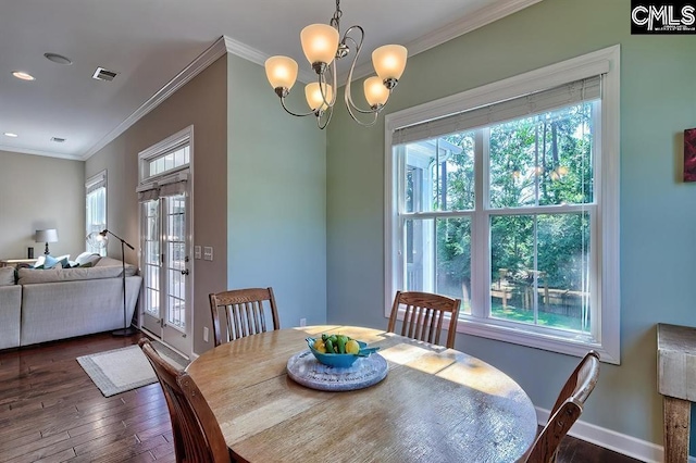 dining area featuring crown molding, a notable chandelier, and dark hardwood / wood-style flooring