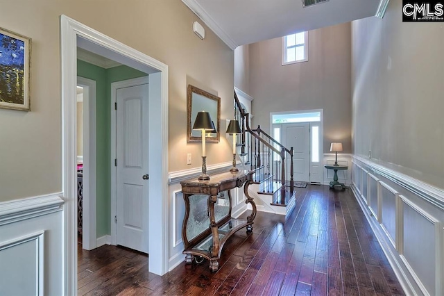 hallway with dark hardwood / wood-style flooring and crown molding