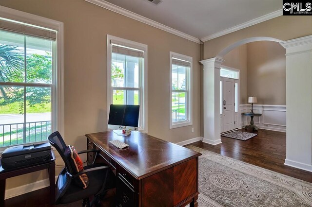 home office featuring dark hardwood / wood-style flooring, crown molding, and ornate columns