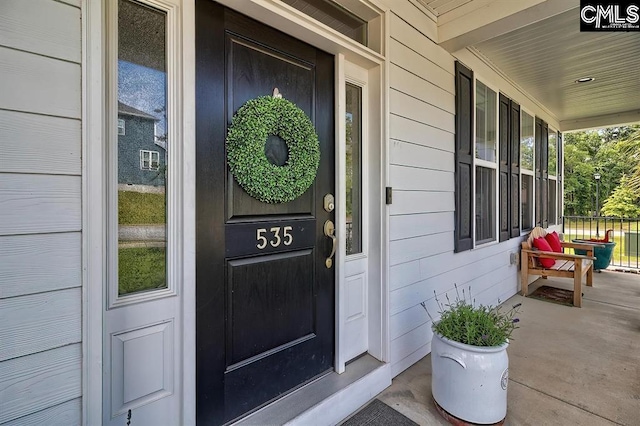 doorway to property featuring covered porch