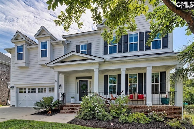 view of front of property featuring a porch and a garage