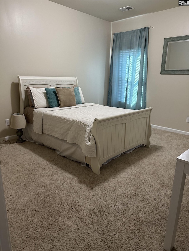 bedroom featuring light colored carpet