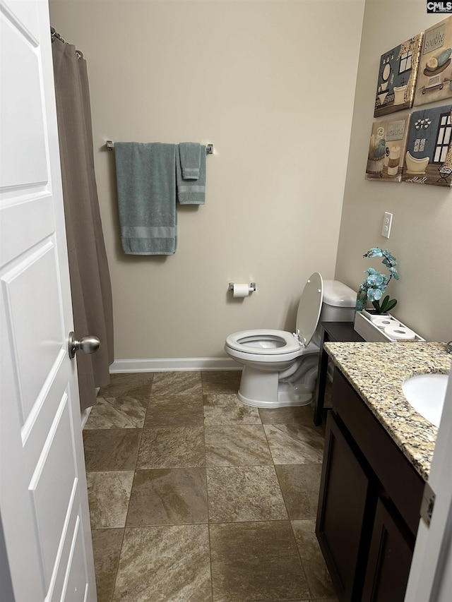 bathroom featuring toilet and vanity