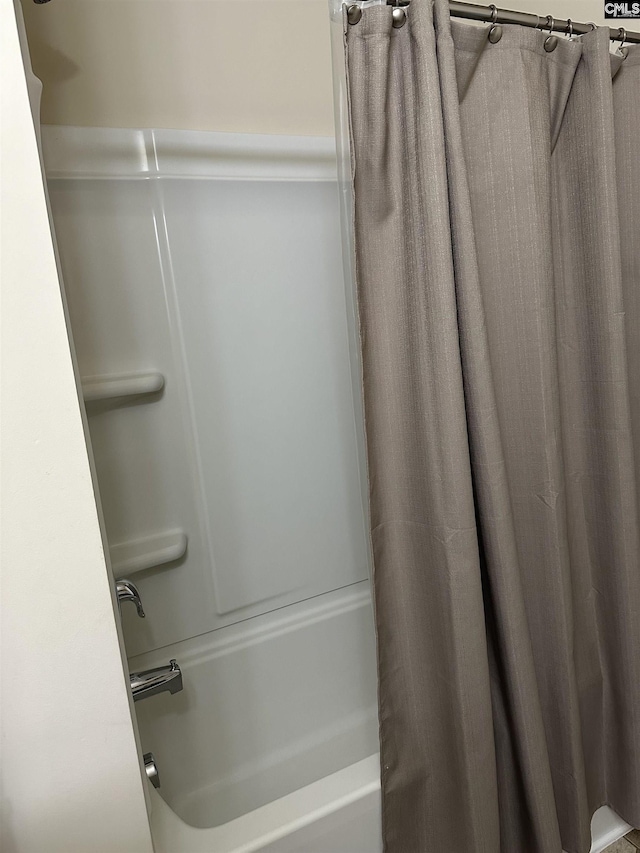 bathroom with shower / bath combo with shower curtain