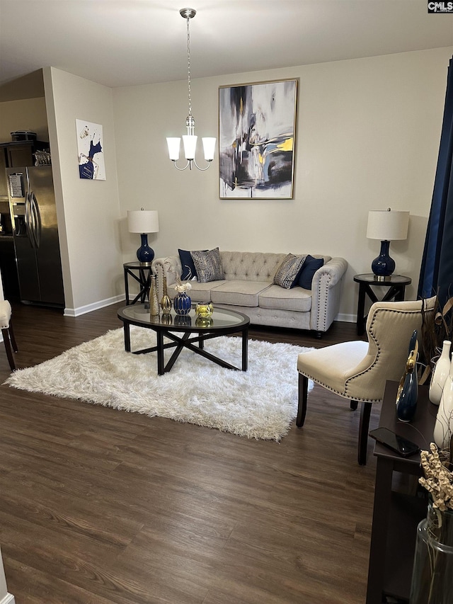 living room with dark hardwood / wood-style floors and a chandelier