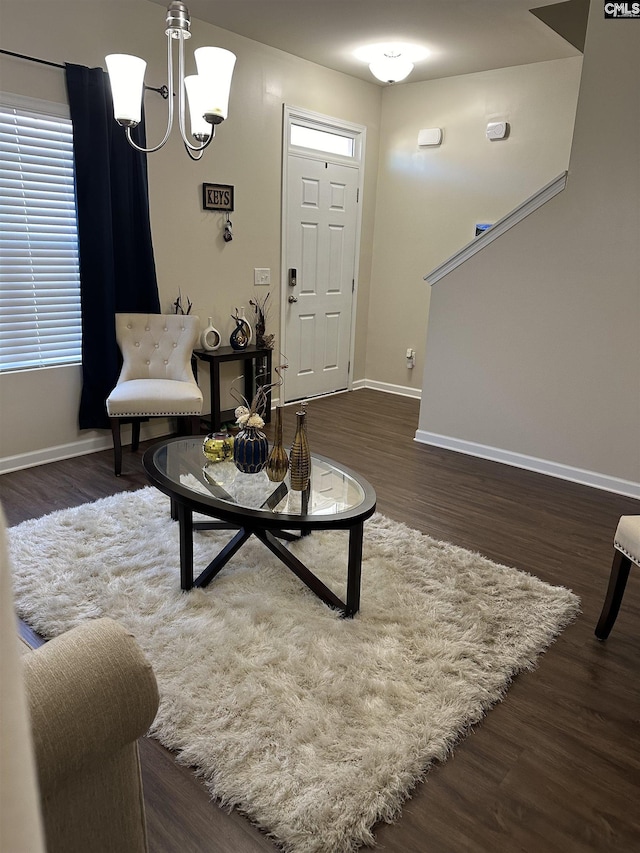 sitting room with a chandelier and dark hardwood / wood-style floors